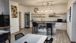 a kitchen with a counter and a table and chairs at HOSTEL Postaja in Ruše