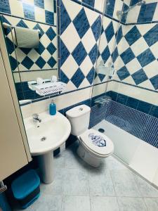 a bathroom with a sink and a toilet and a tub at Maspalomas Casa Oceano in Maspalomas