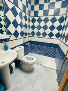 a bathroom with a toilet and a sink at Maspalomas Casa Oceano in Maspalomas +19 photos