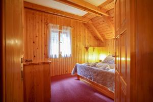 um quarto com uma cama num quarto de madeira em Luxury Love Chalet em Mrkopalj