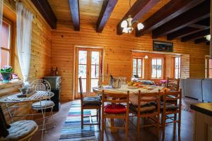 a dining room with a table and chairs at Luxury Love Chalet in Mrkopalj
