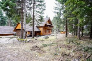 a log cabin in the middle of a forest at Luxury Love Chalet in Mrkopalj