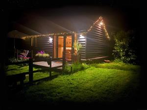 a house lit up at night with lights on it at The Little Barn in Hoxne