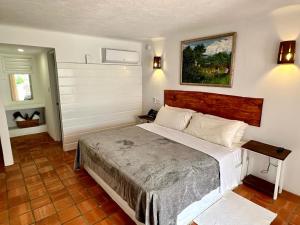 a bedroom with a large bed in a room at OceanBlue Resort in Christ Church +37 photos