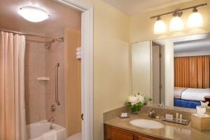 a bathroom with a sink and a shower and a mirror at Residence Inn by Marriott Boston Harbor on Tudor Wharf in Boston