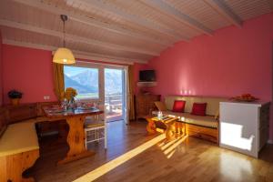 a living room with red walls and a table at Casa del Sole in Colico
