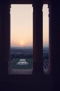 a view of a building with the sunset in the background at Umaid Bhawan Palace Jodhpur in Jodhpur