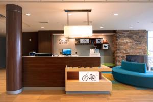 an office lobby with a bike sign on a counter at Fairfield Inn & Suites by Marriott Atlanta Fairburn in Fairburn