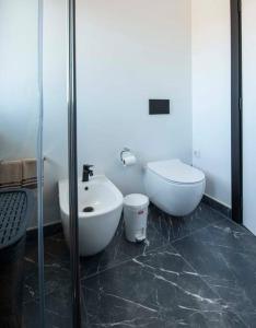 a bathroom with a sink and a toilet at Sunset House in Vila do Bispo