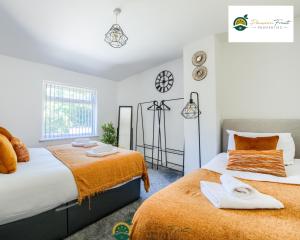 a bedroom with two beds next to each other at 3 Bedroom Coventry House By Passionfruitproperties with Free Wi-fi, Large Garden and Driveway - 52NRC in Coventry