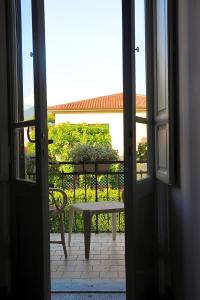 an open door with a bench on a balcony at Hotel Le Giare in Marina di Pietrasanta