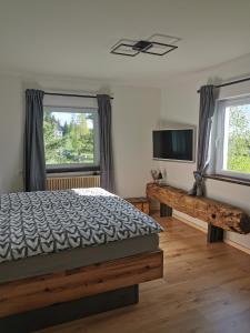 a bedroom with a bed and a flat screen tv at Pine View 