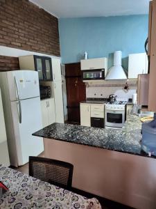 a kitchen with white appliances and a counter top at SAN ANTONIO de Arredondo la casa de Andrea in San Antonio de Arredondo
