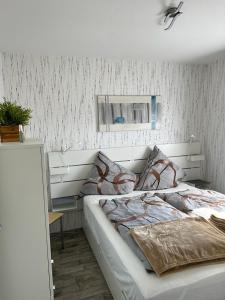 a bedroom with a large bed with a ceiling at Haus Juist-Norddeich in Norden