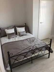 a bed in a white room with pillows on it at Falmouth House 3 Bedrooms 5 Beds Workstays UK in Middlesbrough