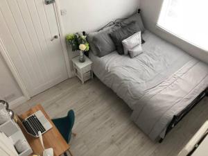 a small bed in a small bedroom with a desk at Falmouth House 3 Bedrooms 5 Beds Workstays UK in Middlesbrough