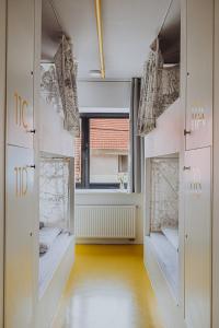 a dressing room with doors and a window at Private Rooms at Hostel63 in Zagreb