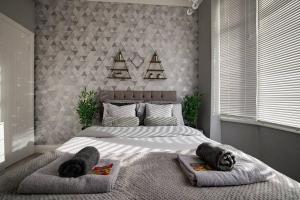 a bedroom with a large bed with two towels on it at Haddon House Workstays UK in Middlesbrough