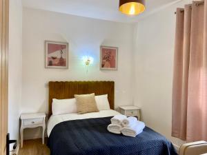 a bedroom with a bed with towels on it at The Old Dance School - 1 and 2 Bedroom Apartments in the Heart of Chesterfield in Chesterfield