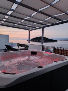 a hot tub on the deck of a house at D-Sunrise in Kali
