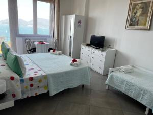 a bedroom with two beds and a television in it at B&B Camera Bellavista in Lerici