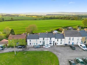 an aerial view of a house with a parking lot at 2 Bed Cottage with Garden & Stunning Field Views in Durham
