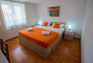 a bedroom with a large bed with two towels on it at Apartman Domenika in Makarska