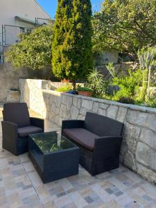 two chairs and a coffee table on a patio at Apartments Cvjetković in Mlini +42 photos