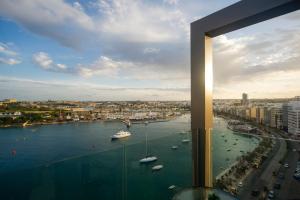 a view of a harbor with boats in the water at The Londoner Hotel Sliema in Sliema
