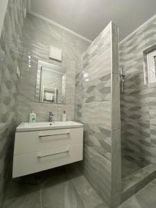 a bathroom with a sink and a shower at Anikó kulcsosház in Corund