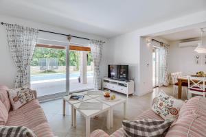 a living room with a couch and a table at Villa Natasha - charming Istrian villa with private heated pool in Ružići