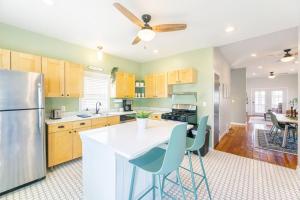 a kitchen with a refrigerator and a table with chairs at Modern, Charming Bungalow by the Park in Saint Paul