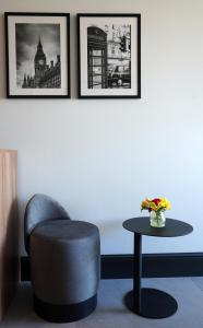 a living room with a chair and a table at The Londoner Hotel Sliema in Sliema