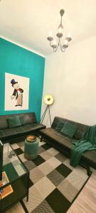 a living room with a couch and a table at My city apartment- Vienna ArtRoom in Vienna