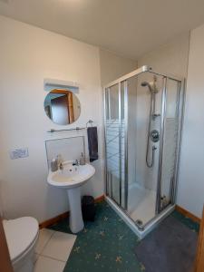 a bathroom with a shower and a sink and a toilet at Ocean Surf in Clashnessie