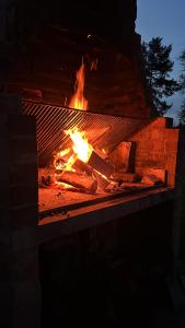 a fireplace with a fire in it at night at Pension Hirsch in Fluorn