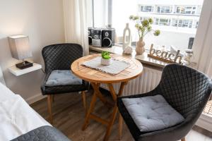 a room with a table and two chairs at Strandnah in Westerland (Sylt)