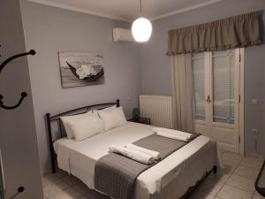 a bedroom with a bed with white sheets and pillows at Villa Marina in Liapades