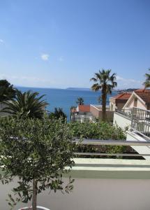 a view of the ocean from the balcony of a house at Pink Inn in Podstrana