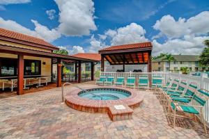 a patio with chairs and a hot tub at Stunning & Serene. Minutes to Anna Maria Island+++ in Bradenton
