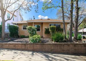 a house with a brick retaining wall and trees at Immaculate Charming Duplex - 2unit in Oroville