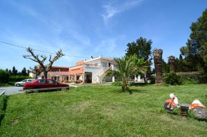 a house with a lawn in front of a house at Hostal La Gola in Torroella de Montgrí