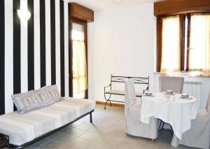 a living room with a couch and a table and chairs at Apartment Il Fiore in Bergamo