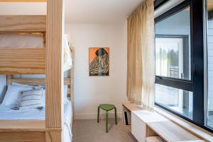 a bedroom with bunk beds and a window at Sea Eagles Landing by Revelstoke Vacations in Revelstoke