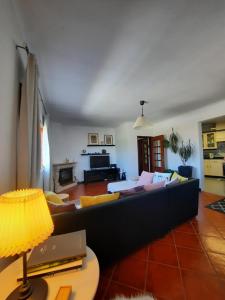 sala de estar con sofá y mesa en Casa das Camélias, en Aveiro