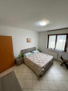 a bedroom with a bed and a chair in it at Casa MALÙ 2 in Latina