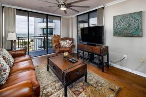 a living room with a couch and a flat screen tv at Nautilus 2407 Gulf View 2 Bedroom 4th Floor Free Beach Service in Fort Walton Beach