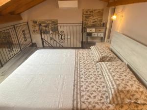 a bedroom with a large bed in a room at Casa Dell’Angelo Serafino in Castelnuovo Magra