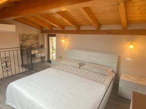 a bedroom with a large bed in a room with wooden ceilings at Casa Dell’Angelo Serafino in Castelnuovo Magra
