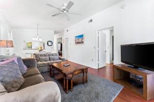 a living room with a couch and a flat screen tv at Minutes to Anna Maria Island in Bradenton